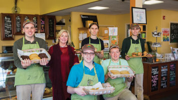 Karen Monroy with members of the Grateful Bites team, from left, Zack, Nate, Eric, Mike and Harry. The bakery is staffed by young adults with developmental disabilities.