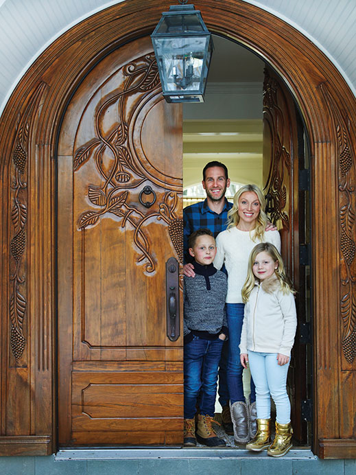 Sebastian and Alexandria join their parents out front; Scott had to convince Marissa that the massive, wooden front door was worth keeping.