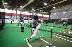 Members of the New Jersey Nationals, a North Caldwell-based club team, practice hitting off a tee during winter workouts at 360 Fitness, an indoor facility in Fairfield.