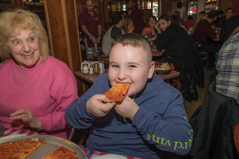 Dolly Van Wetting gets a kick out of great-grandson Jake Knubel's gusto at Kinchley's Tavern.