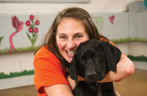 Diane, an inmate at Edna Mahan Correctional Facility for Women in Clinton, shares the love with Roe, a black Lab puppy she's helping train as a bomb sniffer.