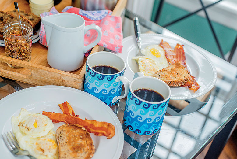 The couple enjoyed breakfast in their brightly colored, sun-splashed room.