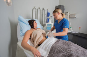 At About Face at Luminous, technician Jessica Carter uses the CoolSculpting machine to treat unwanted fat for her client, Nicole.