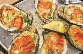 Broiled oysters topped with tomatoes and shallots.