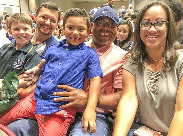 Trebor Melendez sits on dad Robert's lap, next to his mom, Damaris. On the left golfer Isaac Riches, 5, from Australia, who finished third in the U.S. Kids tourney, sits with his father, Damian. Trebor and Isaac became fast friends during the tournament.