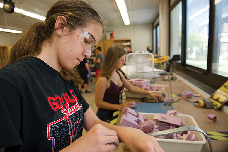 Olivia Garaffa, left, and Jordan Ernst learn about gravity through hands-on exploration in a middle-school STEM class.