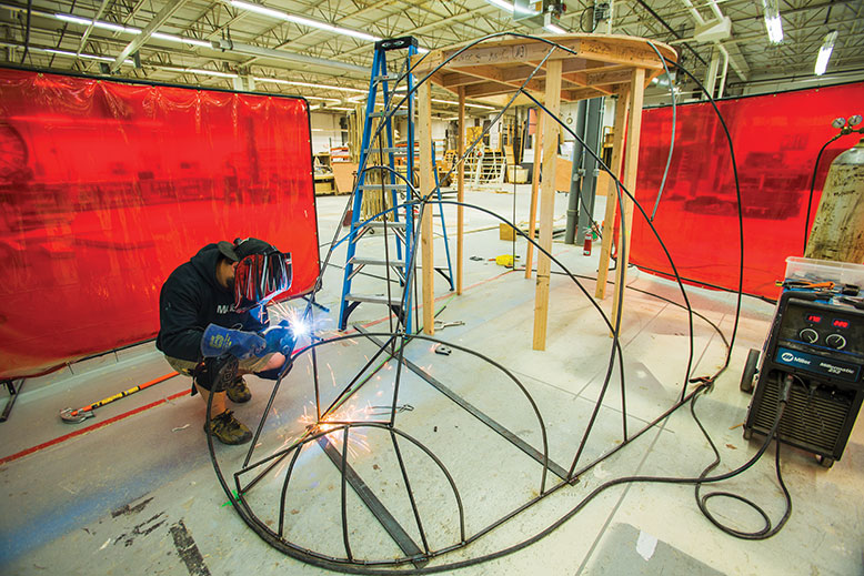 In the Shakespeare Theatre’s 20,000-square-foot design shop, technical director Zac Blitz welds the main scenery piece for Titus Andronicus.