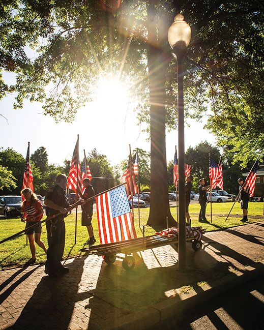 Local volunteers install 2,057 American flags five times a year on Clifton’s Avenue of Flags. Each honors a hometown veteran.