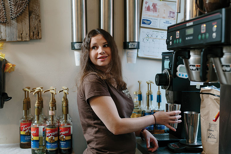 Employee Lauren grinds some fresh beans.