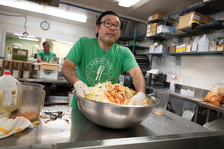 Sam Chung mixes a batch of slaw at the Asbury Park Food Collective.