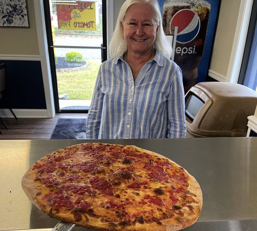 Lillo’s Tomato Pies co-owner presents a pizza.