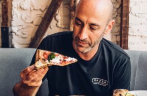 Dan Razza, owner of Razza in Jersey City, prepares to bite into a slice
