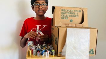 Sri Nihal Tammana poses with a recycling box for an assortment of used batteries