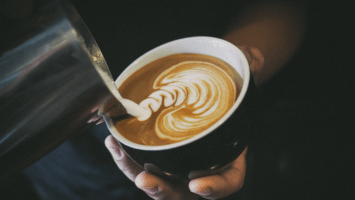 Man making latte art in mug