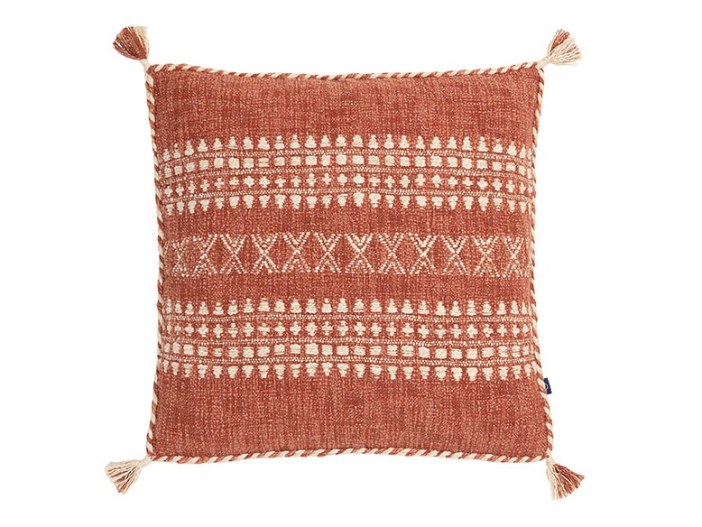 Embroidered pillow in rust tone