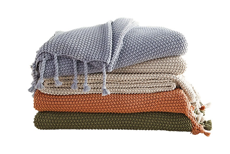 Stack of four blankets in earthy tones from Ballard Designs
