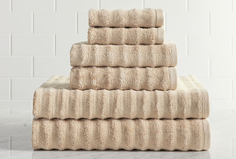 Pile of beige Turkish-cotton towels from Pottery Barn