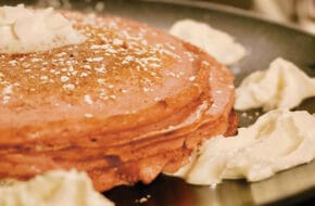 Hot pancakes on a griddle with butter at Elli's Backyard in Red Bank