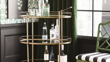 Tessa bar cart with liquor bottles in a home setting