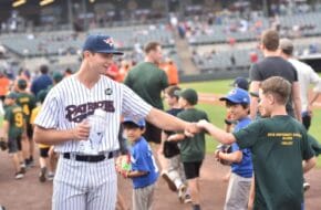Somerset Patriots pitcher Sean Boyle connects with a young fan at the stadium