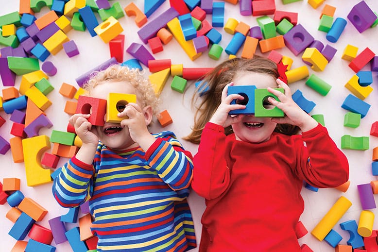 Young children playing with colorful toys