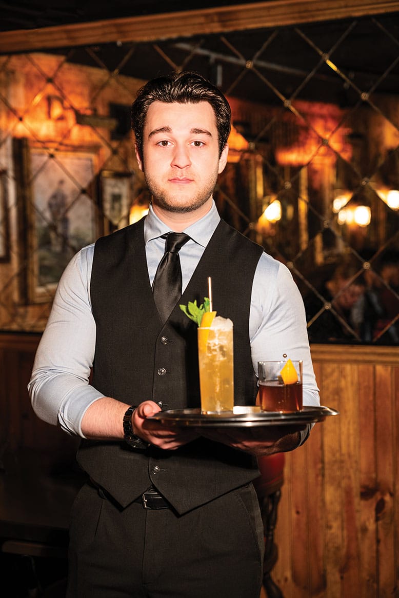 A server with cocktails at The 130 Club in Tenafly, New Jersey