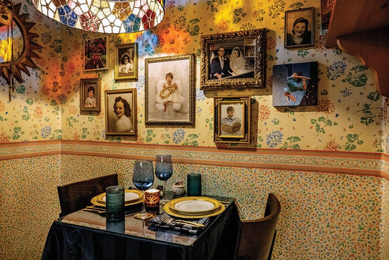 A table under a wall of framed photos at 15 Fox Place in Jersey City, New Jersey