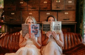 The owners of the Charmed & Bound romance bookshop in Flemington, New Jersey, peeking up from open books