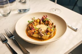 A plate of food on a set table at Revel Hall in Burlington, New Jersey