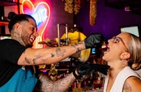 At Bar Mutz in Westwood, chef Robbie Felice feeds a customer fresh mozzarella, much to her delight