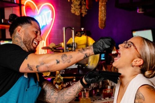 At Bar Mutz in Westwood, chef Robbie Felice feeds a customer fresh mozzarella, much to her delight