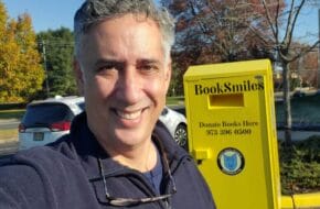 Larry Abrams, founder of New Jersey nonprofit BookSmiles, takes a selfie with a yellow