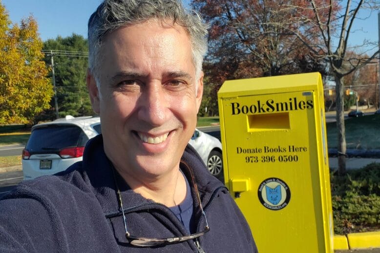 Larry Abrams, founder of New Jersey nonprofit BookSmiles, takes a selfie with a yellow
