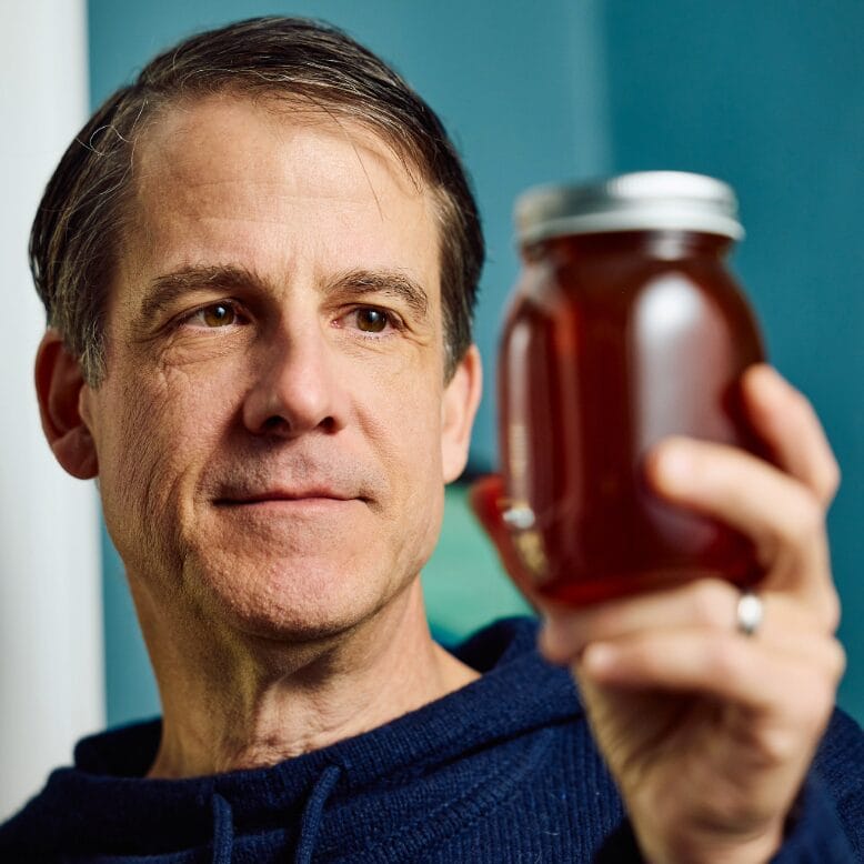 Trenton-based beekeeper Mark Leckington holds a jar of honey