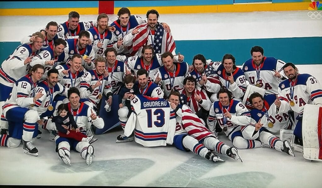 Team USA holds up a Gaudreau jersey to honor late NHL star Johnny Gaudreau after winning Olympic gold.