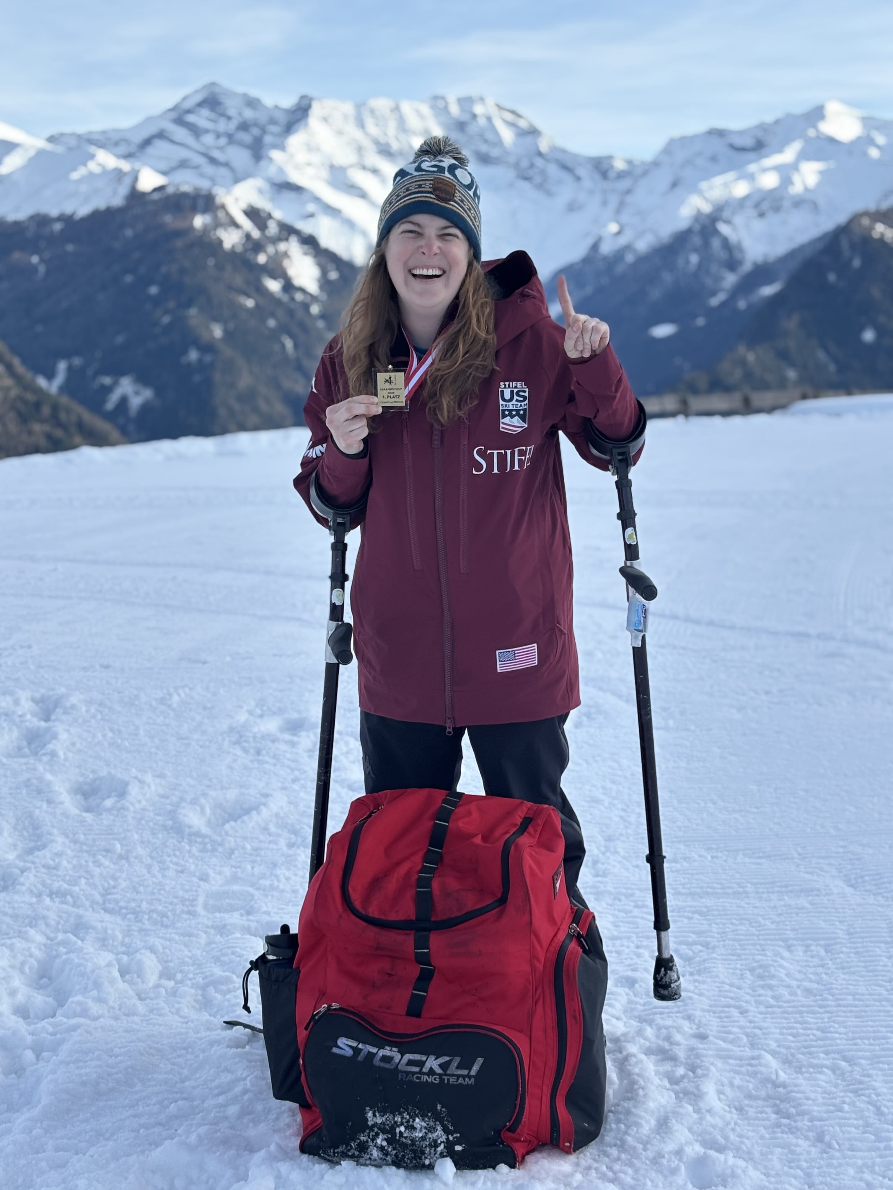 Paralympic skiier Kelsey O'Driscoll on a snowy mountain in Austria with her World Cup medal