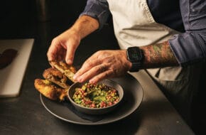 Chef Joey Sergentakis puts the finishing touches on warm smoked-salmon pastrami at Revell Hall in Burlington City, NJ