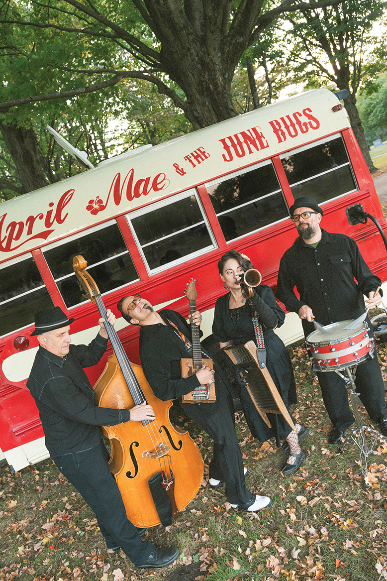 South Jersey band April Mae June Bugs holding instruments in front of their tour bus