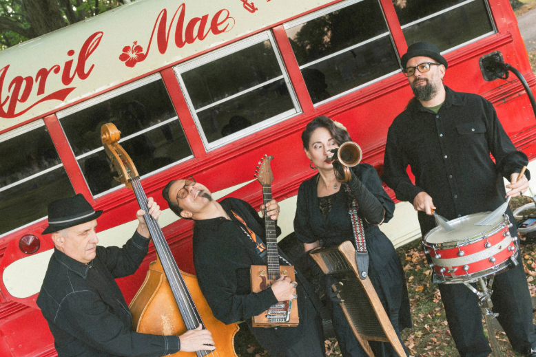 South Jersey band April Mae June Bugs holding instruments in front of their tour bus