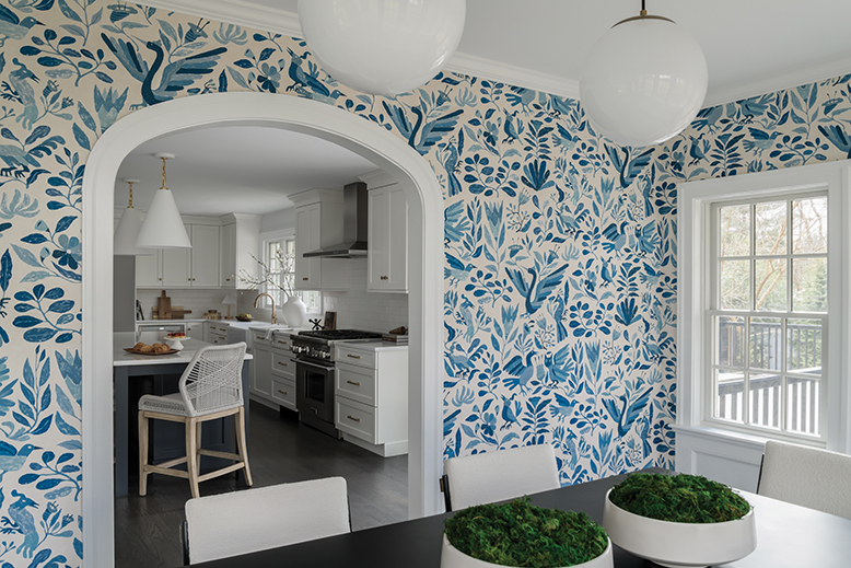 A classically arched doorway creates a seamless flow that bridges the kitchen and sunroom-turned-dining space in this Madison, NJ, home.
