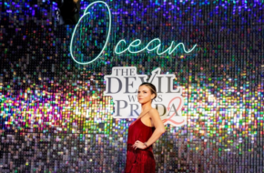 Image of a woman in front of a glittering sign for 'The Devil Wears Prada 2' at Ocean Resort Casino in Atlantic City, NJ
