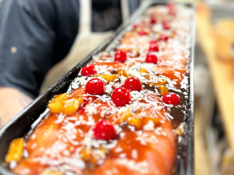 Aproned man with food at Lenny’s Main Street Market in Manasquan, NJ