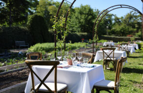 A table set for two in the garden at Beach Plum Farm in West Cape May, NJ