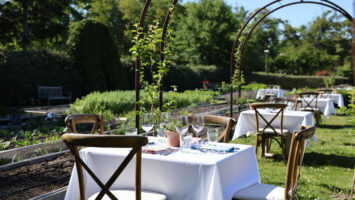 A table set for two in the garden at Beach Plum Farm in West Cape May, NJ