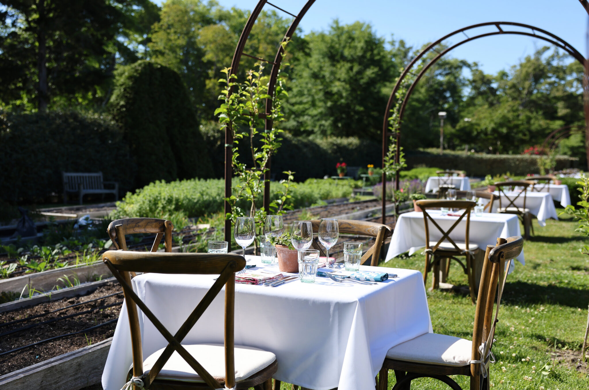 A table set for two in the garden at Beach Plum Farm in West Cape May, NJ