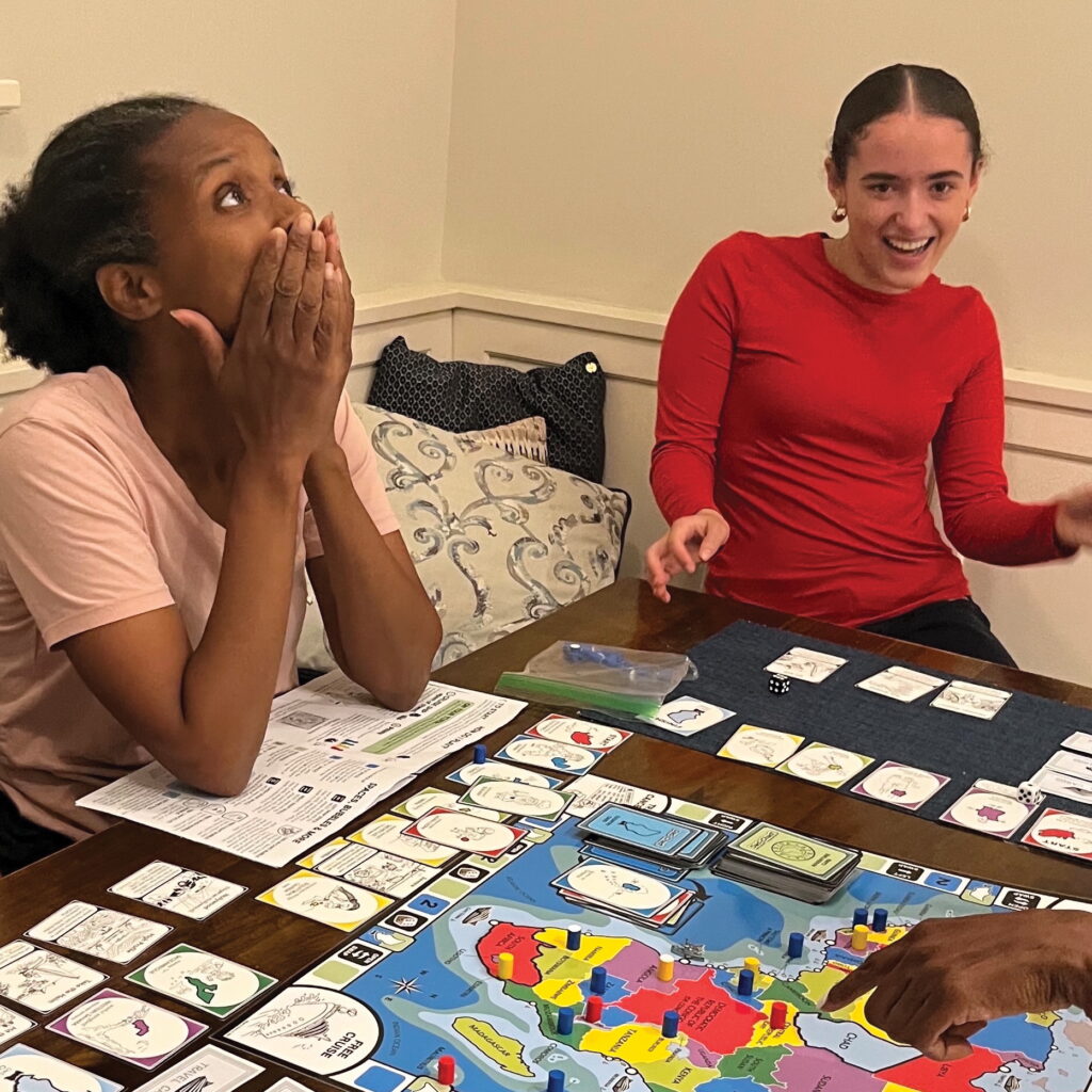 Two girls playing the "Dad in Chad" board game, created by two Montclair moms