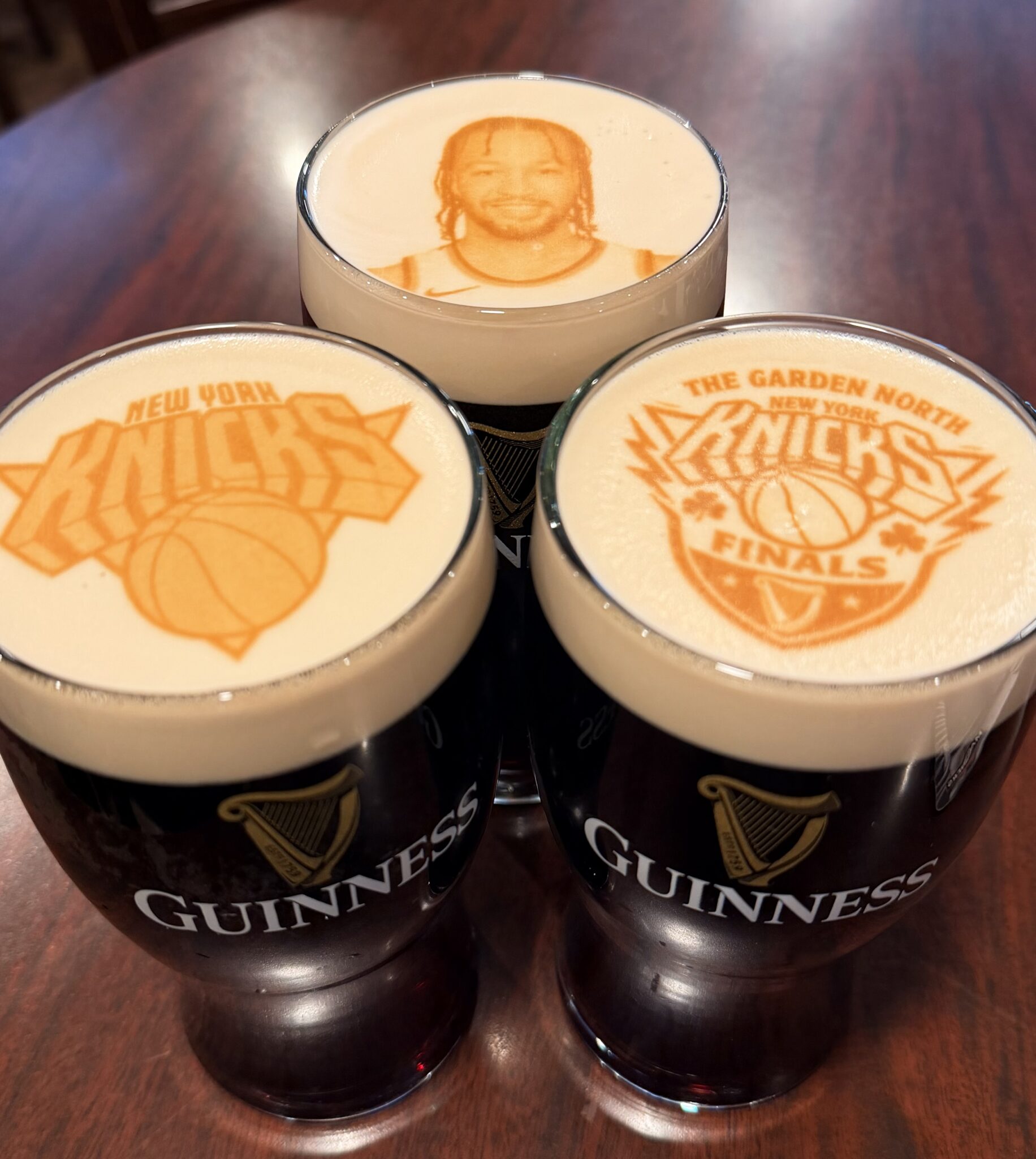Glasses of Guinness with Knicks logos and player Jalen Brunson printed on foam at Cloverleaf Tavern in Caldwell, NJ