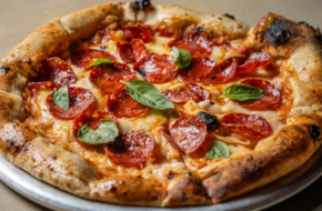 Pizza with pepperoni and basil
