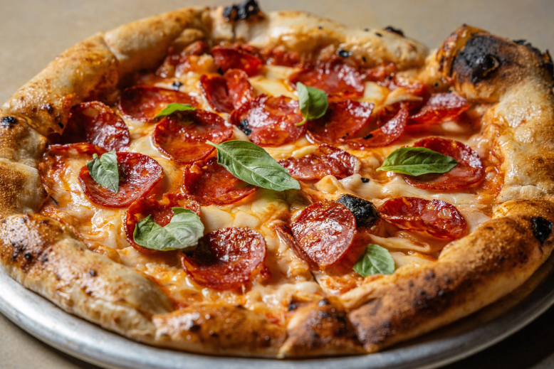 Pizza with pepperoni and basil