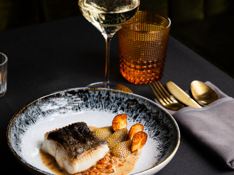 Black cod with sunchoke chips, pineberries (white strawberries) and hazelnuts at Sam's Table in Montclair, NJ